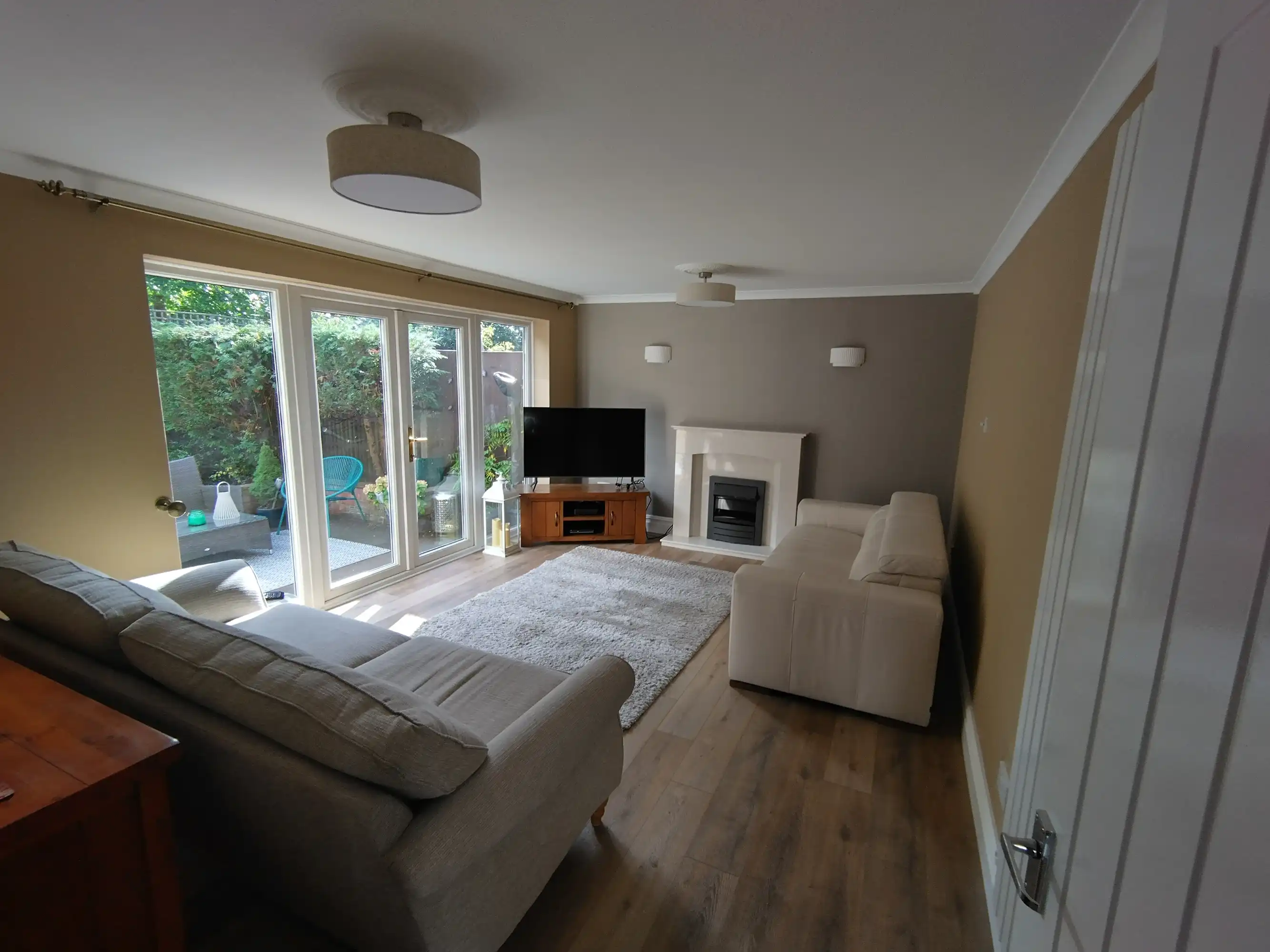 Newly refurbished lounge with patio doors.
